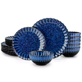 Adonis 18 piece reactive glaze dinnerware set in deep blue with ribbed bowls and plates on a dining table