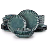 Farmhouse dining table set with Adonis teal green reactive glaze stoneware plates woven placemats and wooden chairs