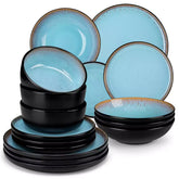 Assorted dishes with soup - dessert - and fruit salad on rustic wooden table - Amber 16-Piece blue stoneware dinnerware set with plates and bowls by vancasso