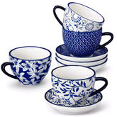 Set of 4 Selene indigo floral porcelain cups and saucers on a wooden table with coffee and pastries featuring blue and white Japanese style mix and match patterns