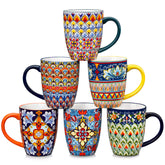 Boho-style coffee mugs filled with creamy latte, colorful porcelain set for cozy mornings
