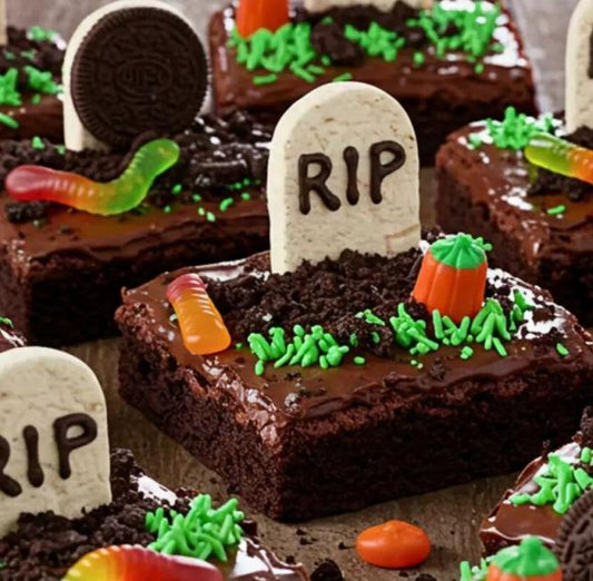 Halloween graveyard chocolate brownies decorated with RIP tombstone cookies, green grass frosting and chocolate crumb dirt
