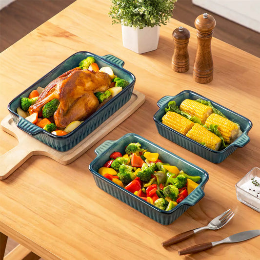 Starry green reactive glaze stoneware bakeware set roast chicken corn vegetables rustic table setting beige wood table.