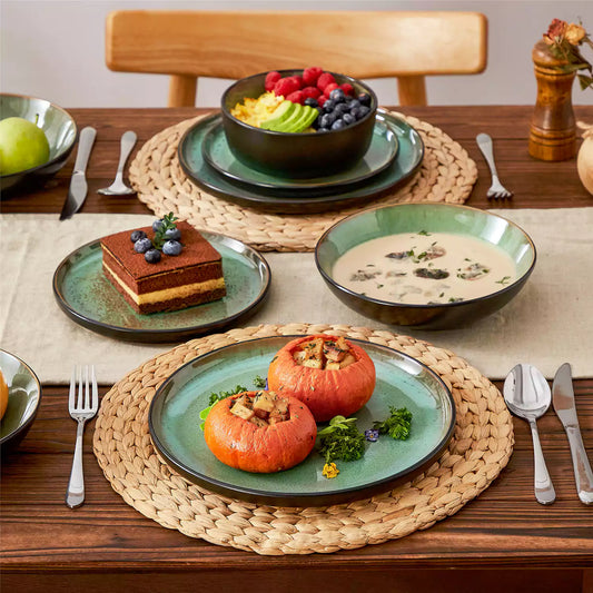 Roasted pumpkin, mushroom soup, chocolate mousse, and fruit salad on Amber green stoneware set with matte black exterior and glossy green glaze