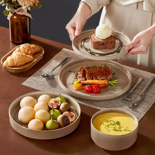 Modern solo dining table setting featuring vancasso Anya caramel stoneware dinnerware with grilled lamb and dessert.