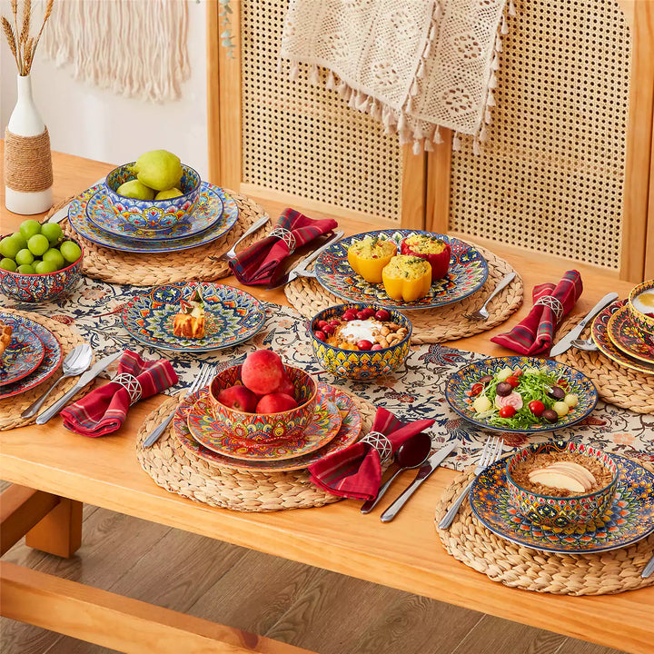 Lumi 18-piece dinnerware set with double-sided bowls on bohemian table, decorated with fresh fruit, oats, and colorful foods.