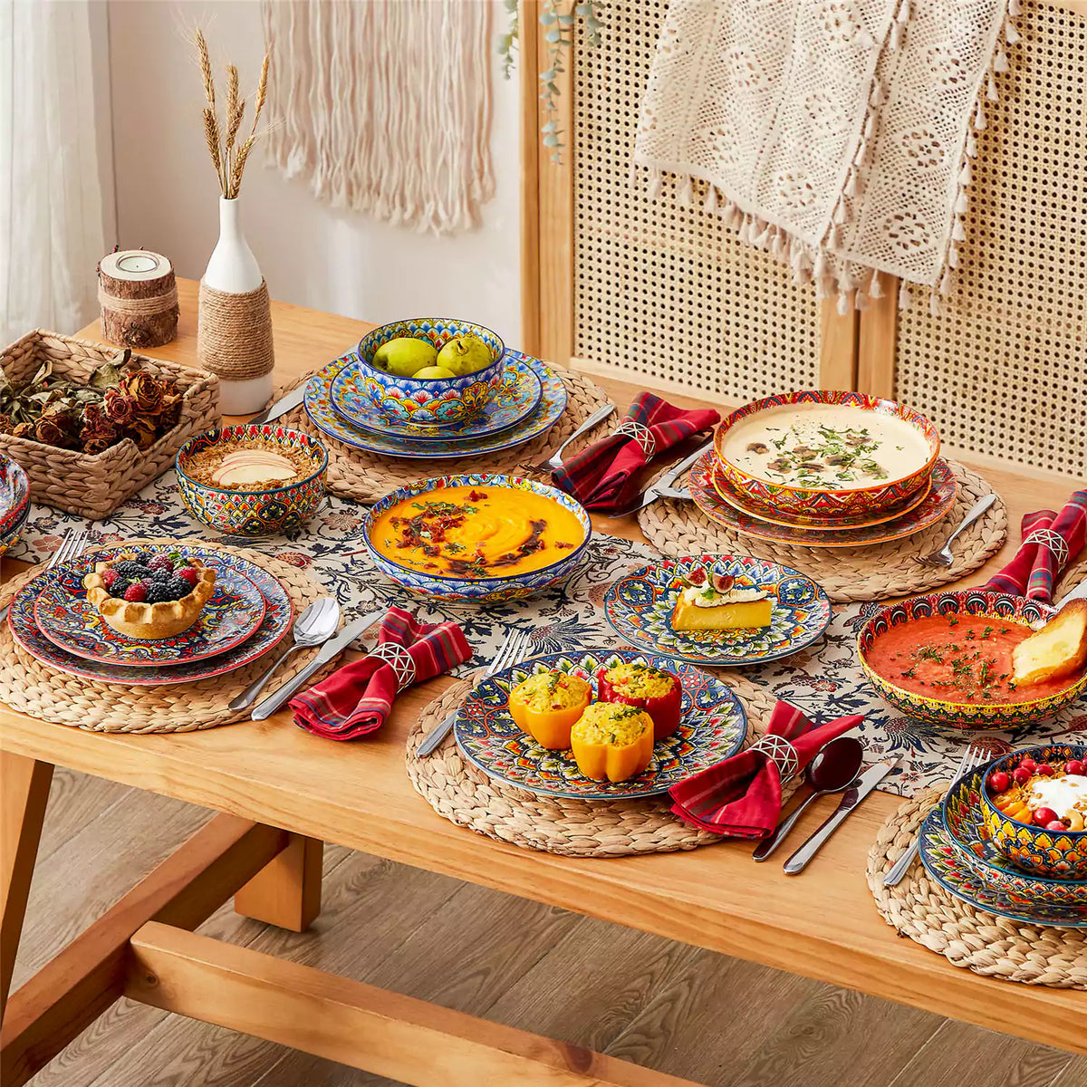 Eclectic table setting showcasing Lumi 24-piece dinnerware with mixed patterns, pasta bowls filled with food, candles, and textured linens.