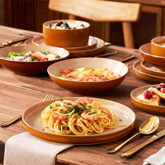 Close-up of a onion stoneware plate featuring shrimp pasta on a dark brown wooden dining table with a rich food setup.