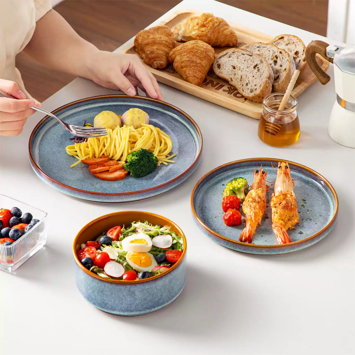 Onion 18-piece stoneware dinnerware set with pasta, baked cheese shrimp, fruit salad, and bread for solo dining