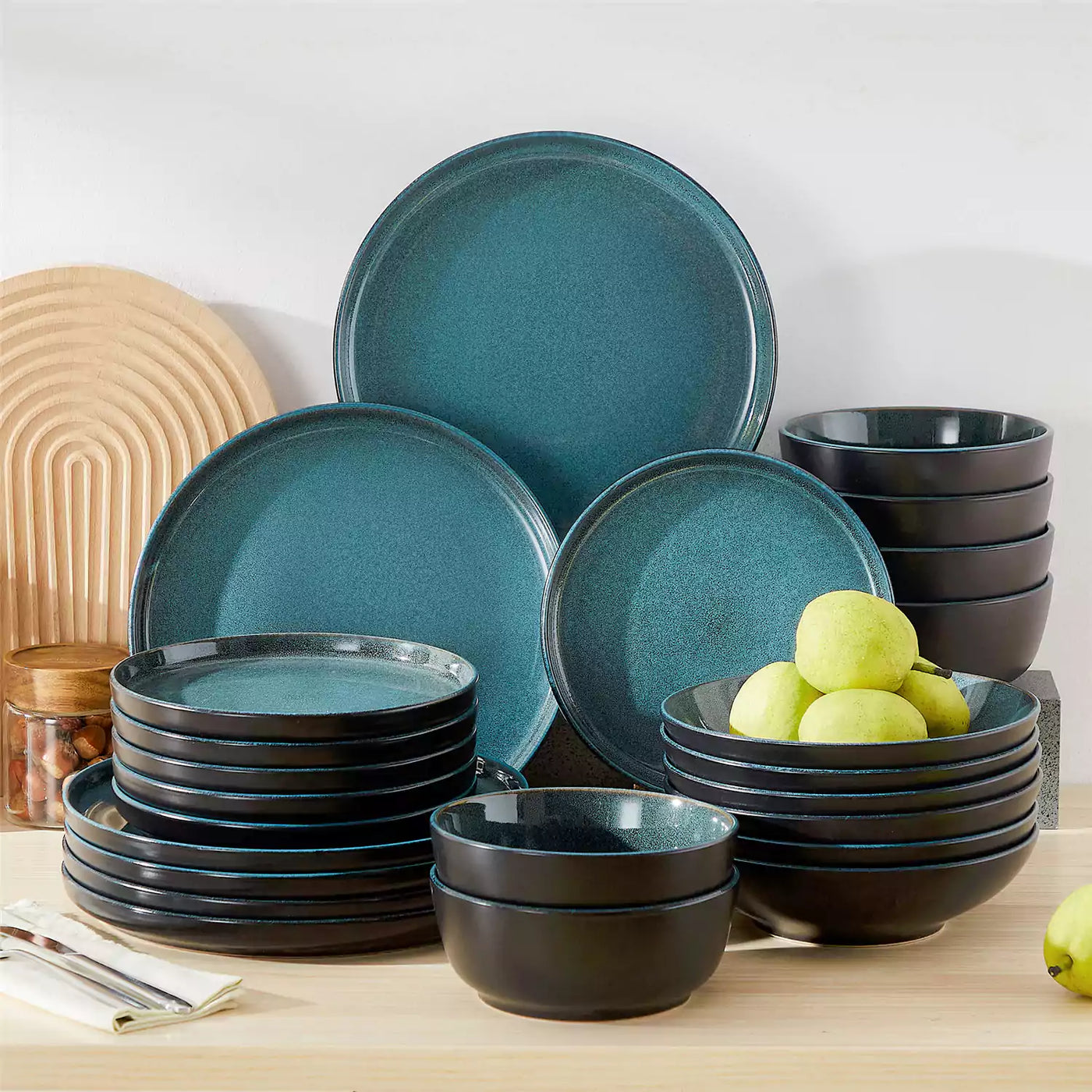 Glossy teal Playa stoneware dinnerware set for six, stacked on table with pears in soup bowls