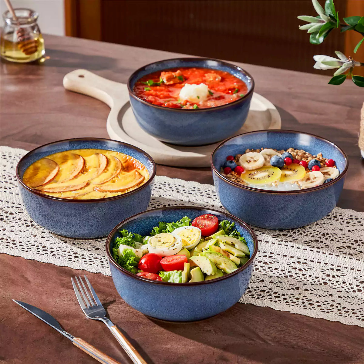Sata stoneware cereal bowls set of 4 in ocean blue, artisan reactive glaze finish, everyday breakfast styling on dark farmhouse table.