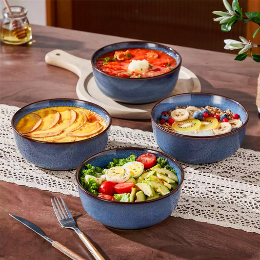 Sata stoneware cereal bowls set of 4 in ocean blue, artisan reactive glaze finish, everyday breakfast styling on dark farmhouse table.