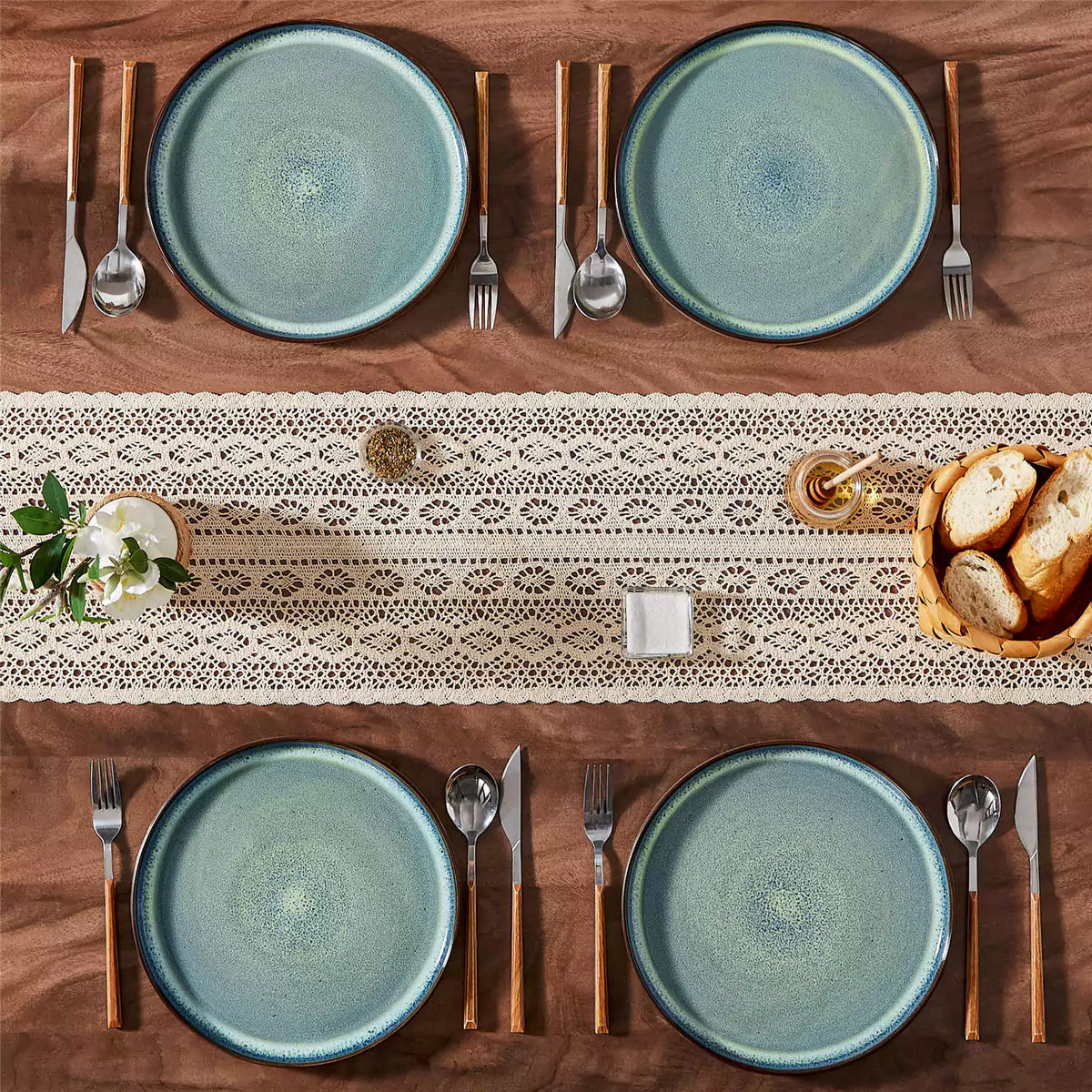 Sata green stoneware dinner plates set of 4 on rustic wood table with lace table runner bread basket honey jar and greenery farmhouse reactive glaze.