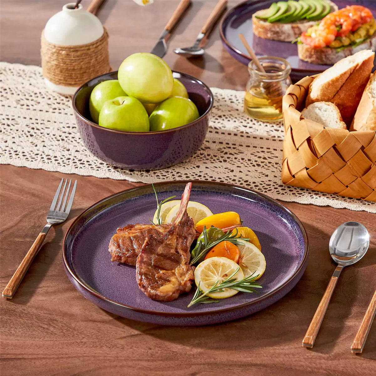 Sata purple stoneware dinner plate with grilled lamb chops, paired with matching cereal bowl on a wood table with lace runner