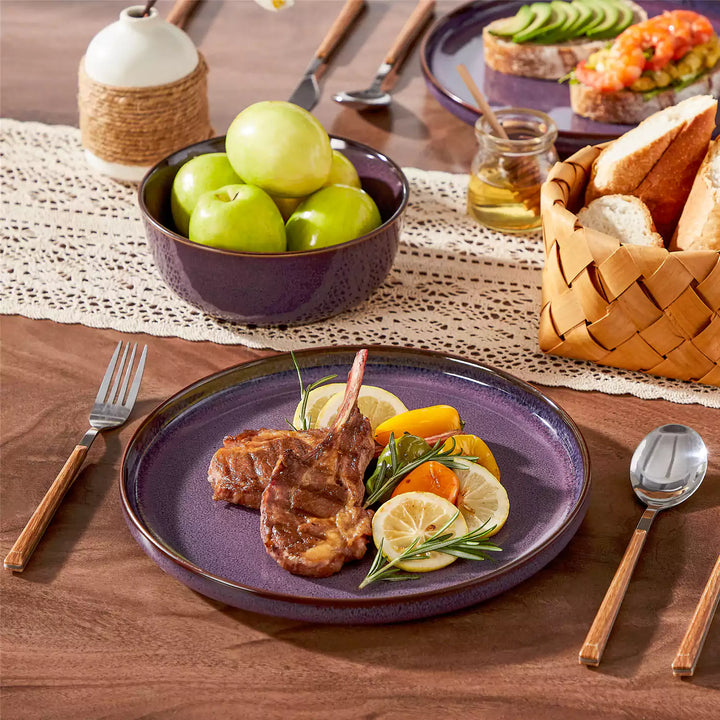 Sata purple stoneware dinner plate with grilled lamb chops, paired with matching cereal bowl on a wood table with lace runner
