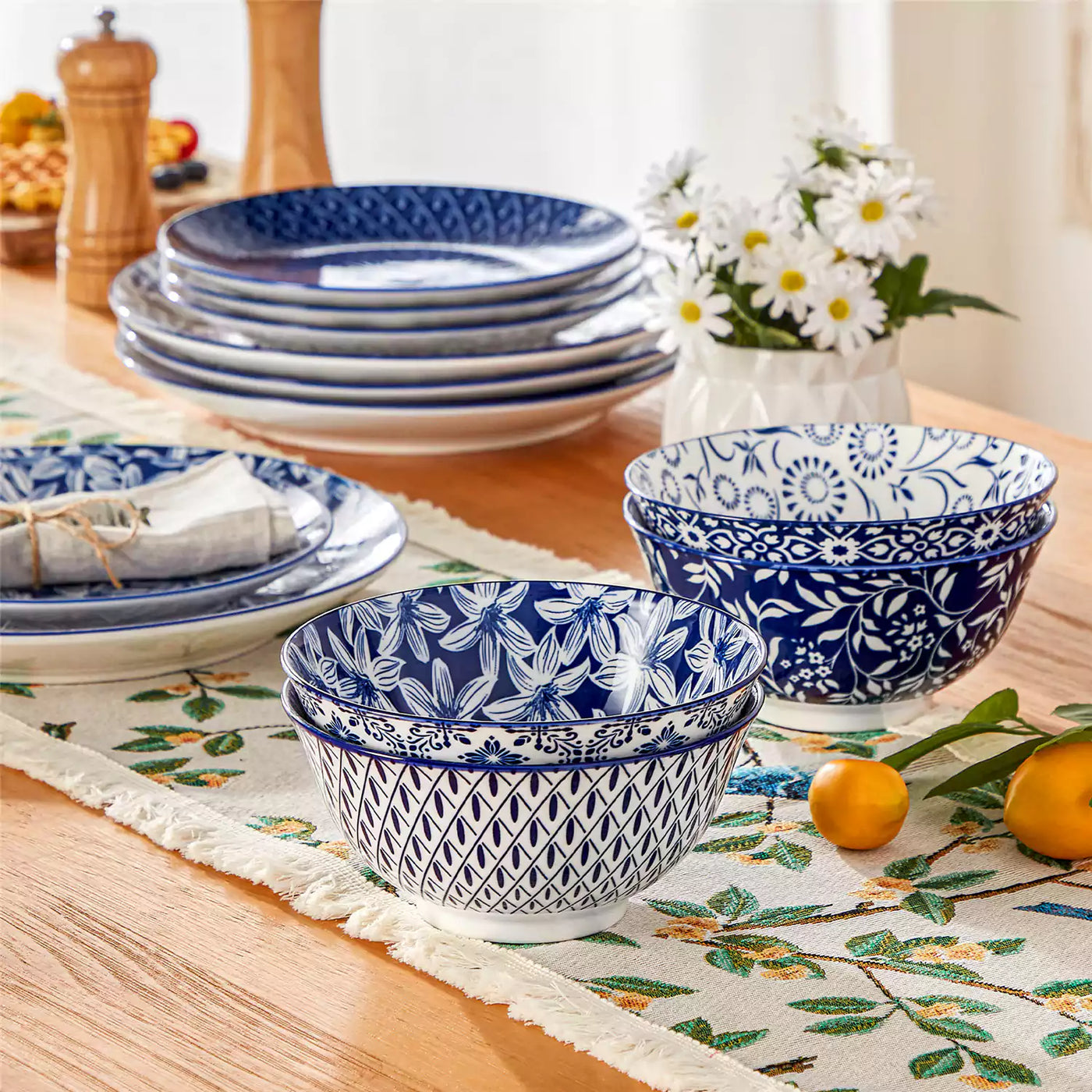 Selene porcelain cereal bowls paired with matching tableware on a wood table with floral runner.