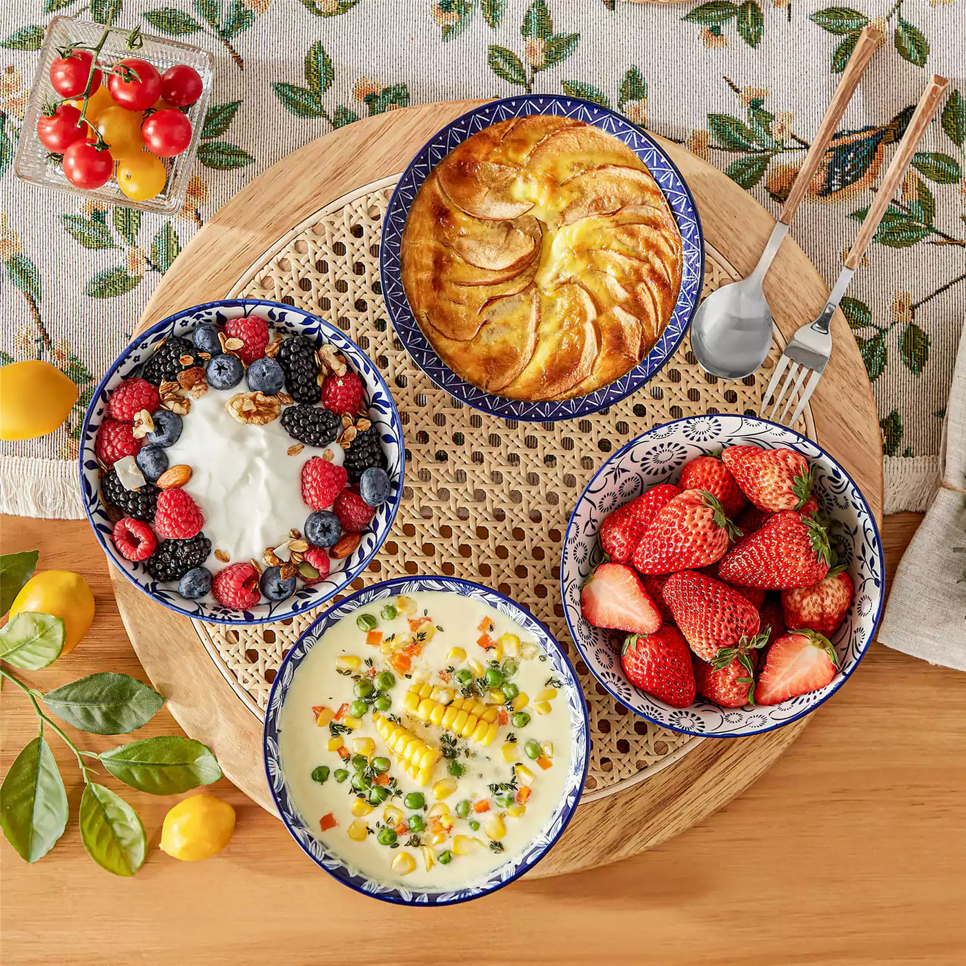 Selene indigo floral porcelain bowls flat lay yogurt berries corn soup baked apple linen tablecloth.