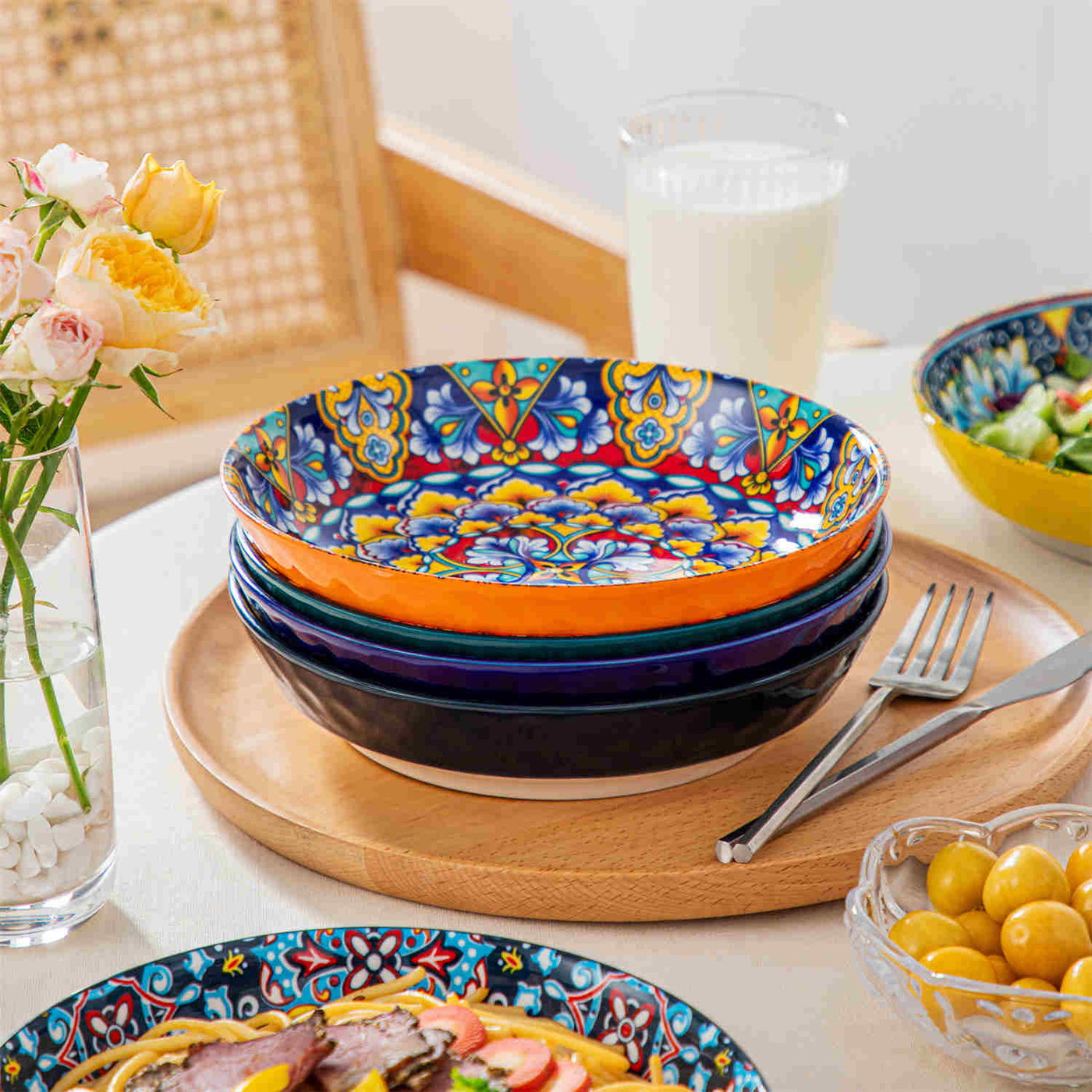 Simi Bohemian pasta bowls set of 6 with spaghetti and fruit salad, displayed on a wooden tray with flowers and milk.