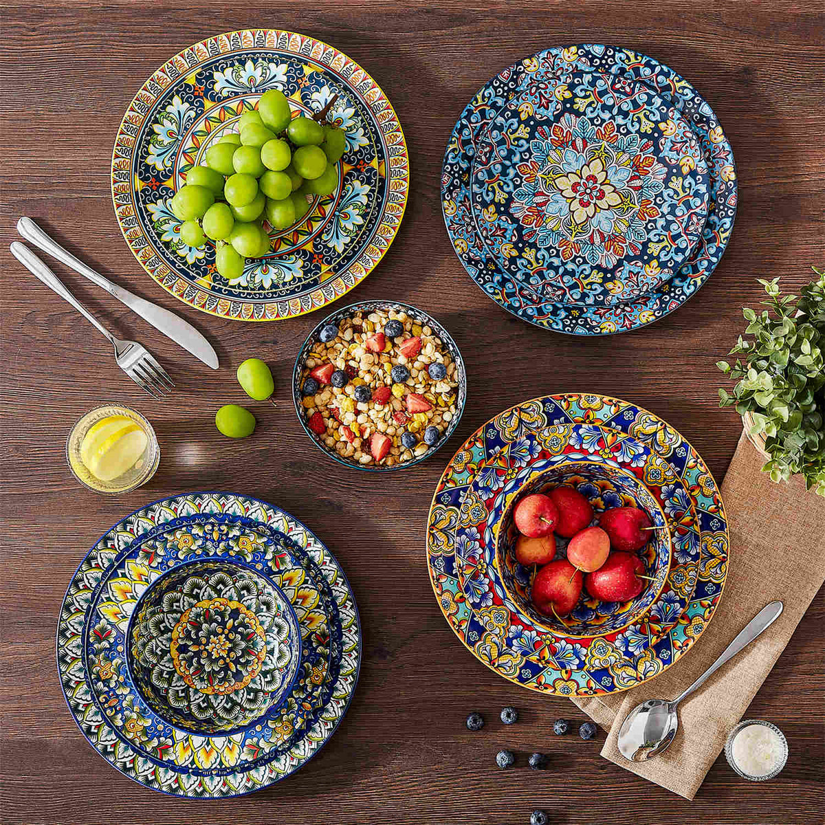 Simi 18-piece porcelain set displayed on dark wood tabletop with fruit, oatmeal, and patterned bowls.