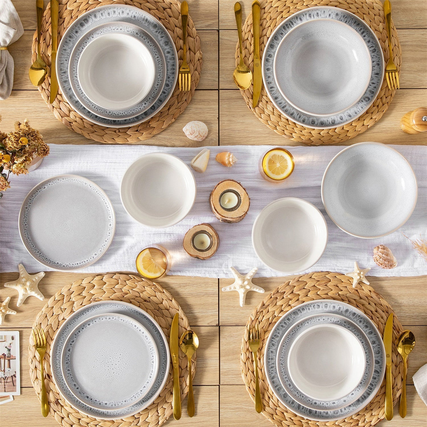 Beige and cream-white reactive glaze dinnerware set on woven placemat with tropical table decor, featuring starfish and seashells.
