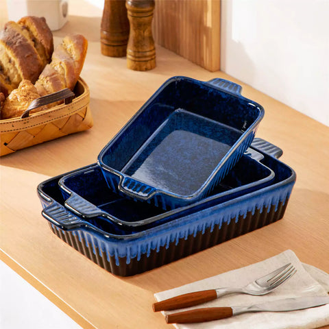 Starry 3 piece stoneware bakeware set with reactive glaze in navy blue on a wooden table