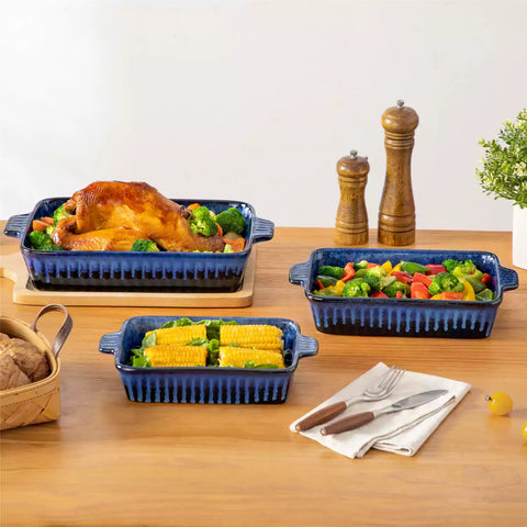 Starry 3 piece stoneware bakeware set with reactive glaze in navy blue on a wooden table