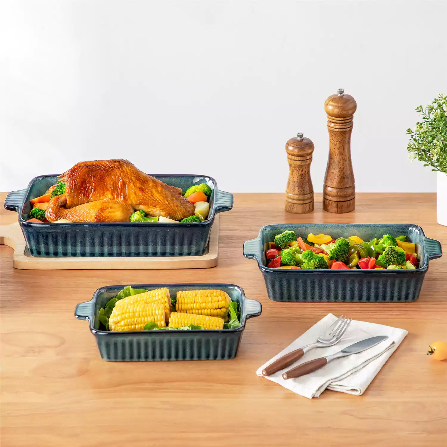 Starry 3 piece stoneware bakeware set with reactive glaze in green on a wooden table