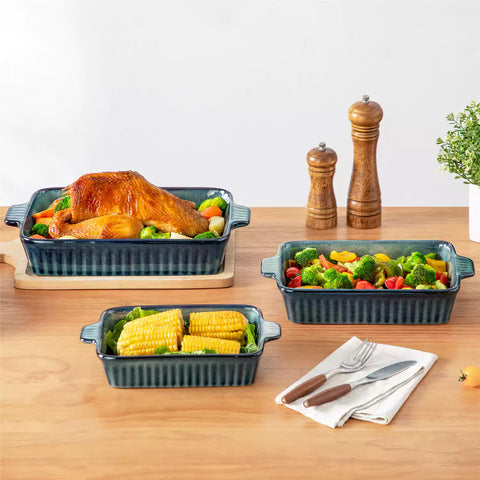 Starry 3 piece stoneware bakeware set with reactive glaze in green on a wooden table