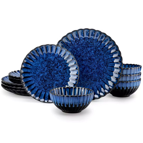 Blue reactive glaze stoneware bowls and plates from the Adonis 12 piece set with brown placemats and fresh flowers