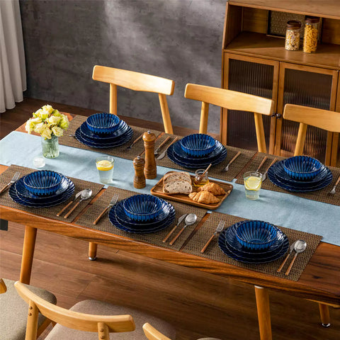 Farmhouse dining table set with Adonis teal blue reactive glaze stoneware plates woven placemats and wooden chairs