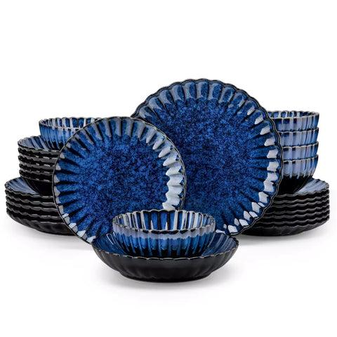 Farmhouse dining table set with Adonis teal blue reactive glaze stoneware plates woven placemats and wooden chairs