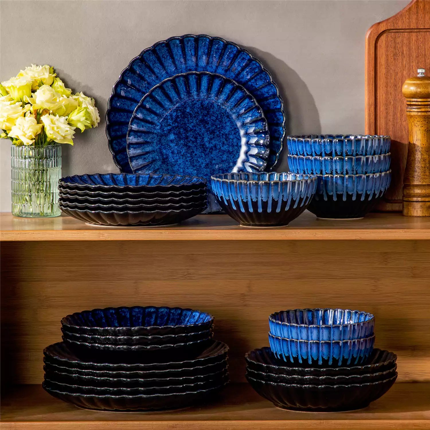 Farmhouse dining table set with Adonis teal blue reactive glaze stoneware plates woven placemats and wooden chairs