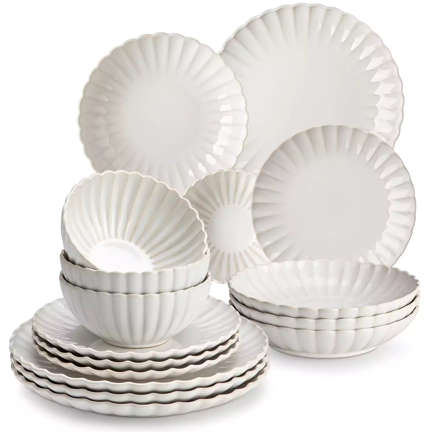 Adonis 16 piece reactive glaze dinnerware set in beige with pasta steak and fruit on a wooden dining table