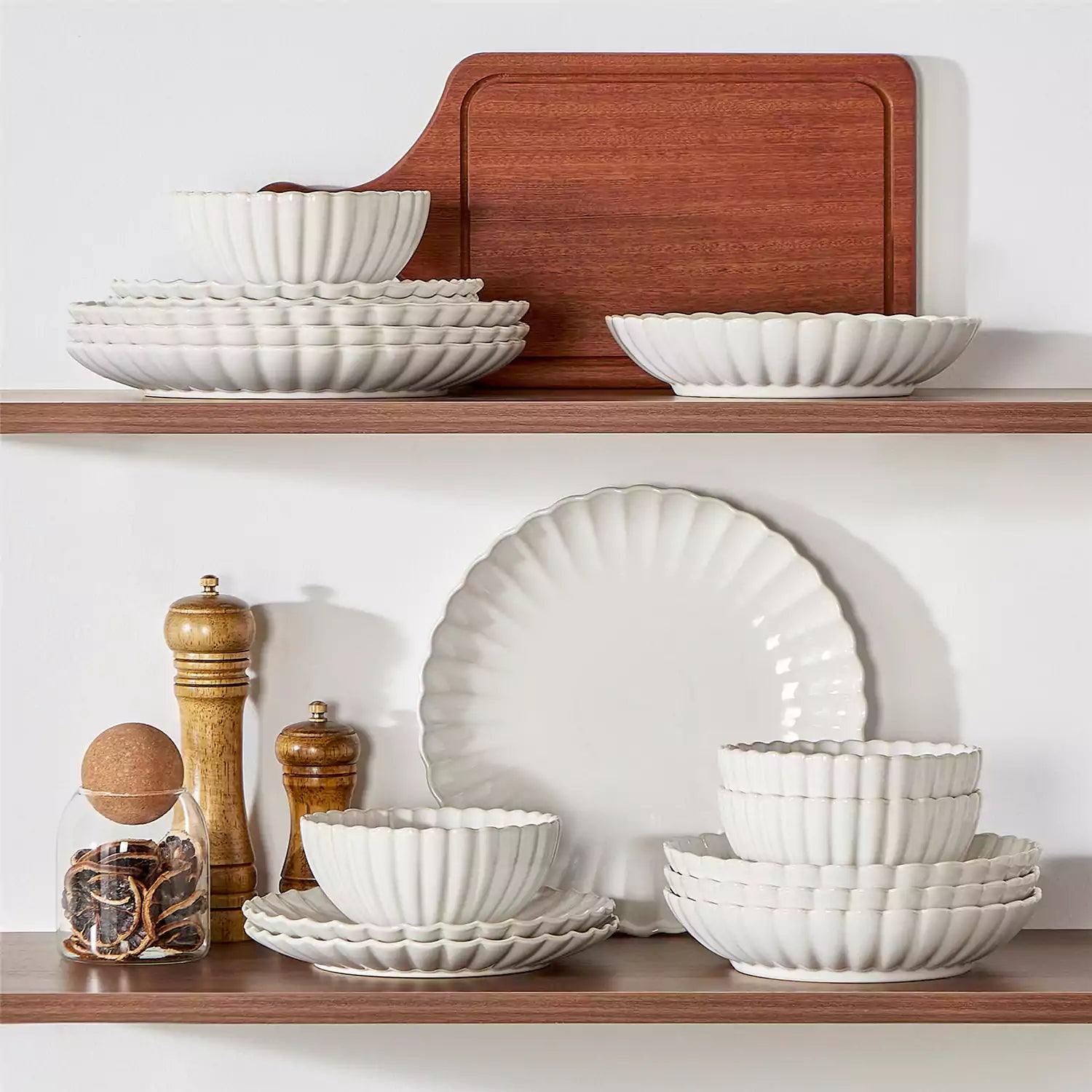 Adonis 16 piece reactive glaze dinnerware set in beige with pasta steak and fruit on a wooden dining table