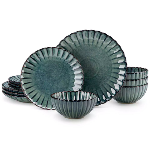 Green reactive glaze stoneware bowls and plates from the Adonis 12 piece set with brown placemats and fresh flowers