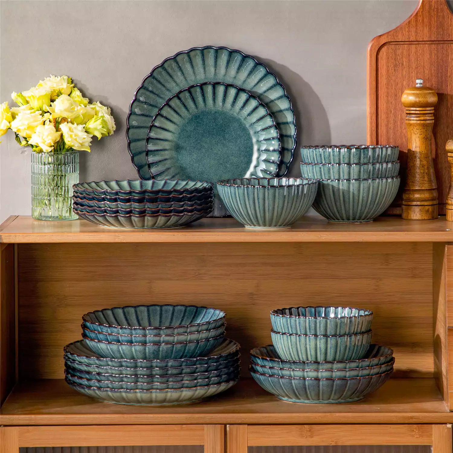Farmhouse dining table set with Adonis teal green reactive glaze stoneware plates woven placemats and wooden chairs