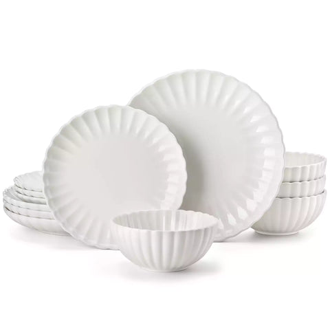 Bright modern dining room with Adonis white porcelain plates bowls white chairs and light wood accents
