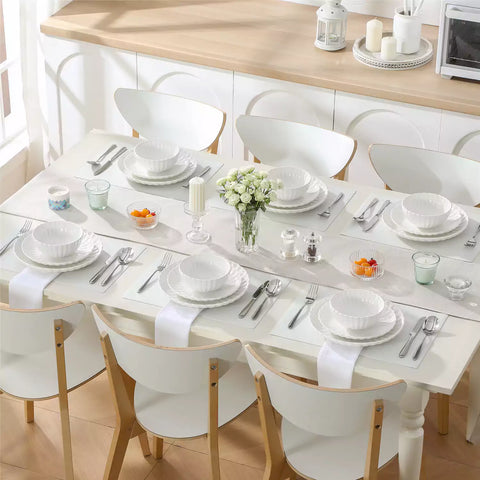 Adonis 18 piece white porcelain dinnerware set styled with food and glassware on a modern dining table