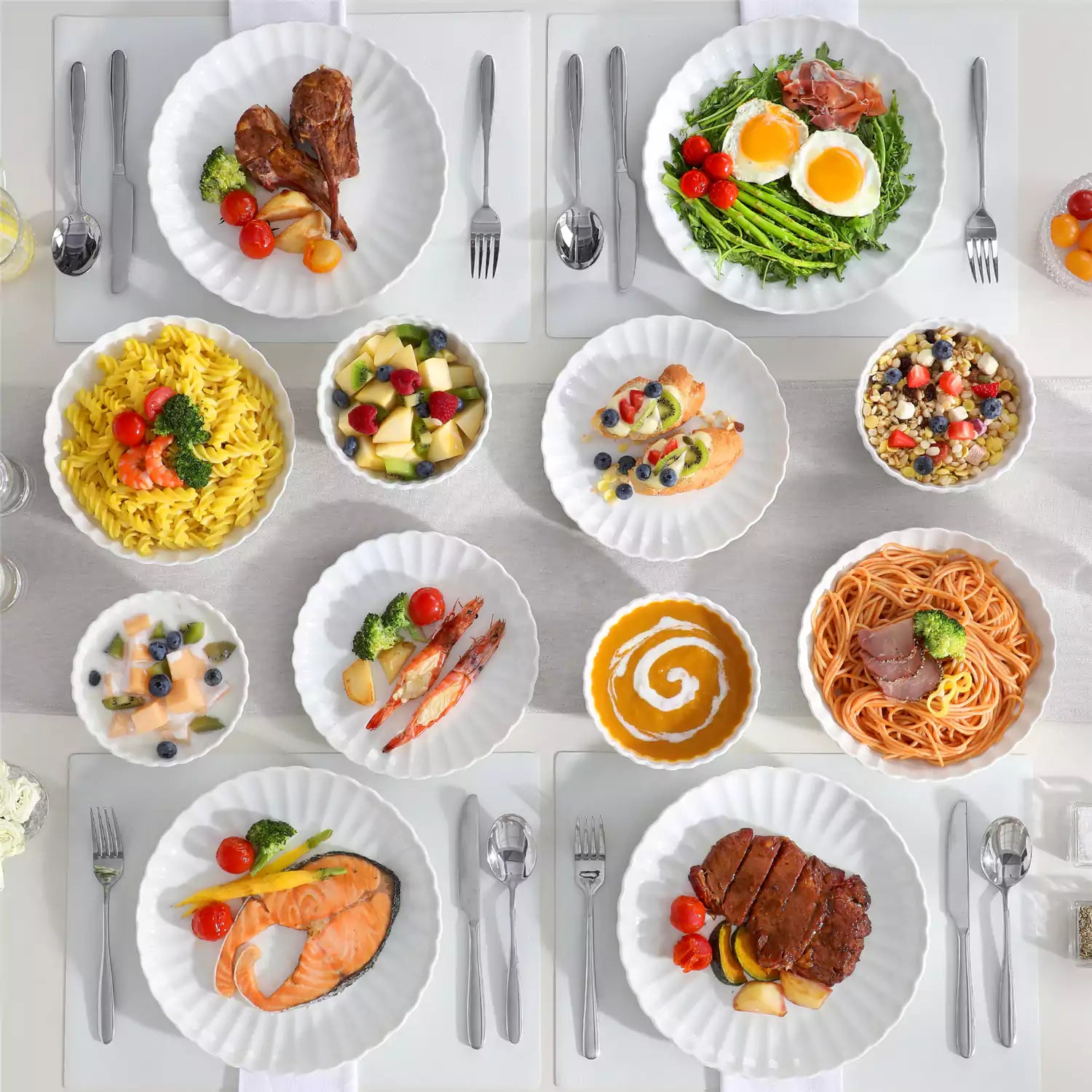 Adonis 24 piece white porcelain dinnerware set for 6 styled with pasta soup and fruit on a modern dining table