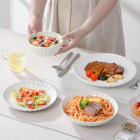 Adonis 24 piece white porcelain dinnerware set for 6 styled with pasta soup and fruit on a modern dining table