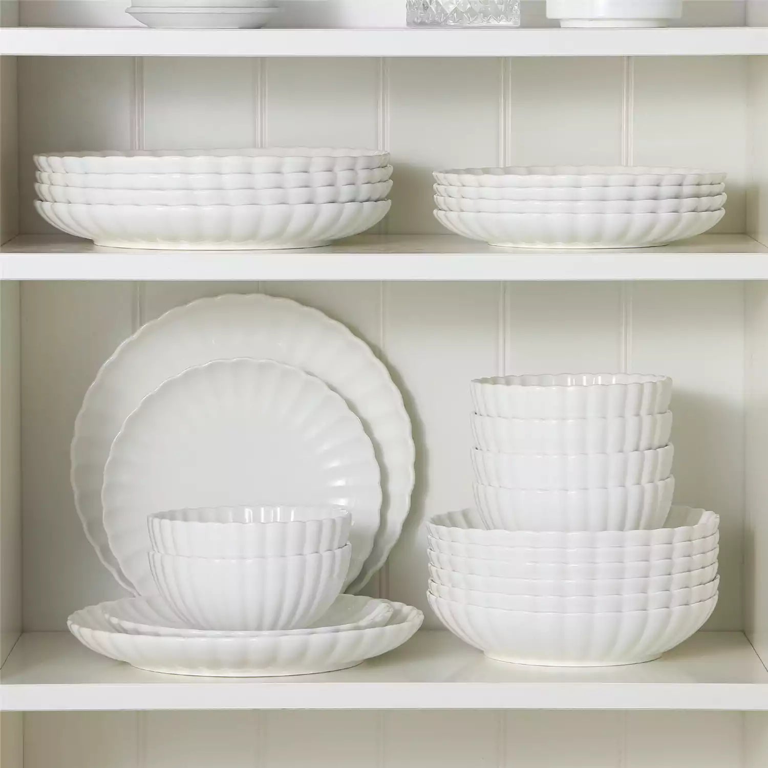 Adonis 24 piece white porcelain dinnerware set for 6 styled with pasta soup and fruit on a modern dining table