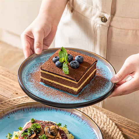 Rustic dining table with Amber 12-piece stoneware dinnerware in farmhouse blue - featuring reactive glaze plates - bowls - and utensils by vancasso