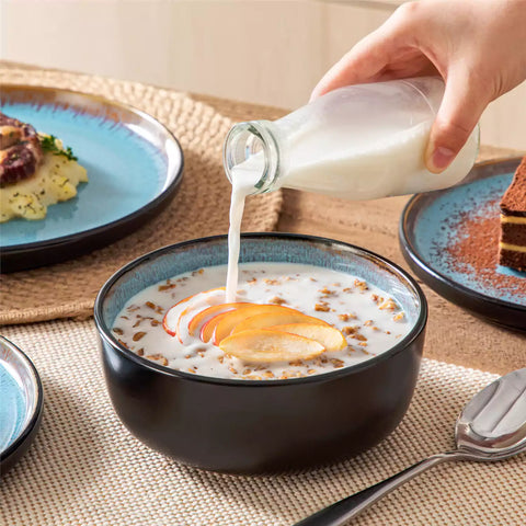 Rustic dining table with Amber 12-piece stoneware dinnerware in farmhouse blue - featuring reactive glaze plates - bowls - and utensils by vancasso