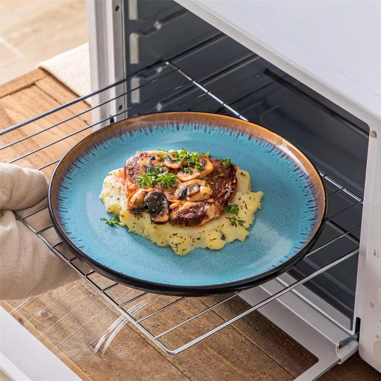 Rustic dining table with Amber 12-piece stoneware dinnerware in farmhouse blue - featuring reactive glaze plates - bowls - and utensils by vancasso