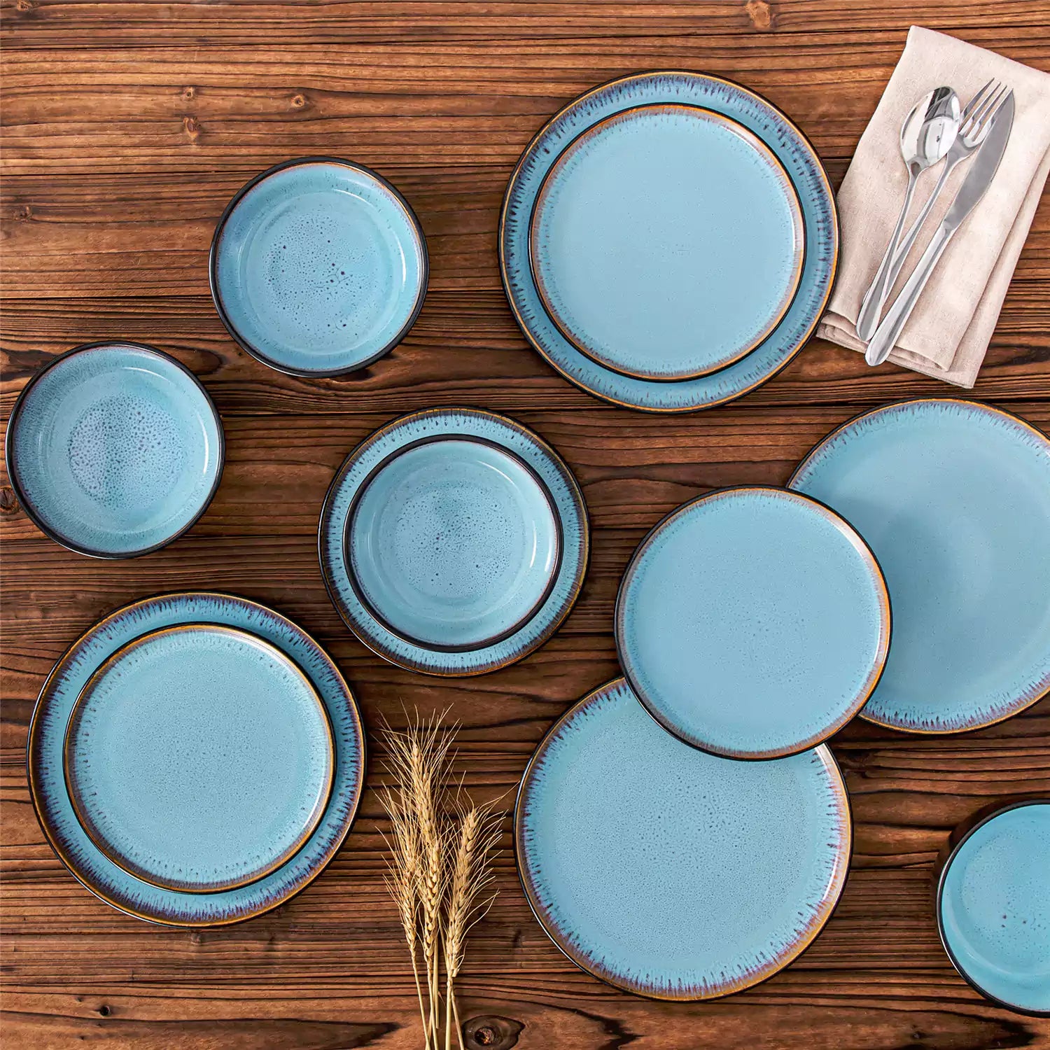 Rustic dining table with Amber 12-piece stoneware dinnerware in farmhouse blue - featuring reactive glaze plates - bowls - and utensils by vancasso