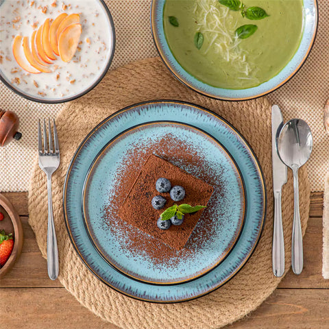 Assorted dishes with soup - dessert -  and fruit salad on rustic wooden table - Amber 16-Piece blue stoneware dinnerware set with plates and bowls by vancasso