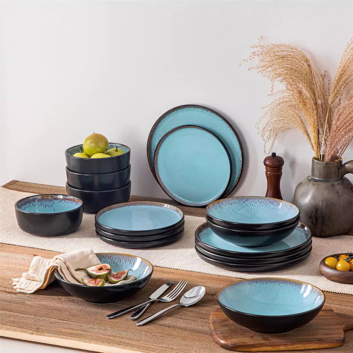 Assorted dishes with soup - dessert - and fruit salad on rustic wooden table - Amber 16-Piece blue stoneware dinnerware set with plates and bowls by vancasso