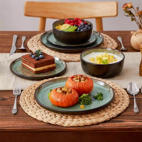 Rustic dining table with Amber 12-piece stoneware dinnerware in farmhouse green - featuring reactive glaze plates - bowls - and utensils by vancasso