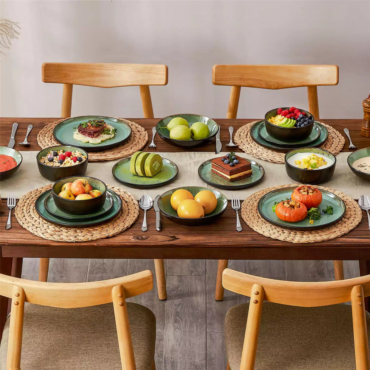 Assorted dishes with soup - dessert - and fruit salad on rustic wooden table - Amber 16-Piece green stoneware dinnerware set with plates and bowls by vancasso