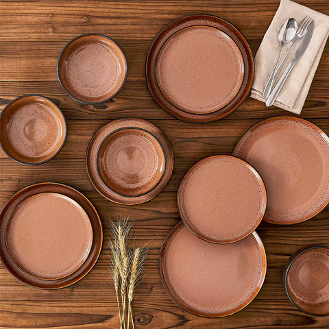 Rustic dining table with Amber 12-piece stoneware dinnerware in farmhouse red - featuring reactive glaze plates - bowls - and utensils by vancasso